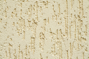 Beige plastered wall texture. Seamless surface and abstract solid background. Pale painted wall built structure.