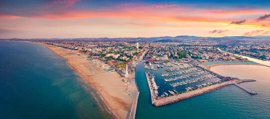 Panoramic summer view from flying drone of Libera Rimini public beach. Captivating evening scene of...