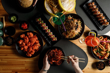 Overhead view of table with Chinese food. Dark moody stock image