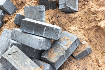 Dismantled paving slabs. Reconstruction of the sidewalk in the city. Construction work on the improvement of the territory. Close-up. Background.