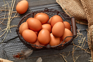 Brown eggs on rustic background