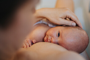 Mother with baby boy in bathroom at home