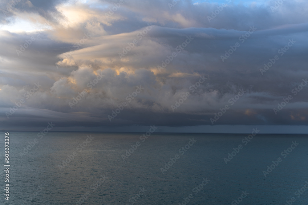Wall mural dramatic sky over the sea at sunrise