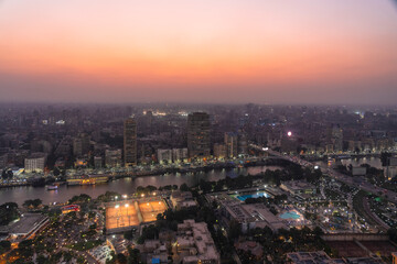 Egypt, Cairo, Elevated view of Gezira, Agouza, Dokki and Mohandeseen districts at dusk with sporting clubs in foreground