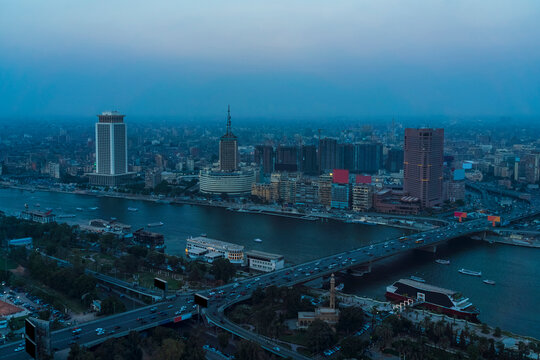 Egypt, Cairo, River Nile, Qasr El Nil Bridge and surrounding downtown buildings at dusk