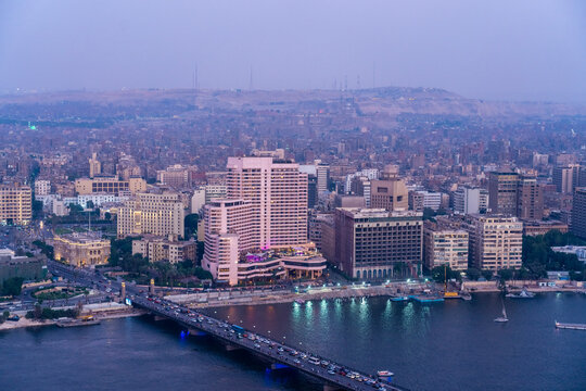Egypt, Cairo, River Nile, Qasr El Nil Bridge and surrounding downtown buildings at dusk