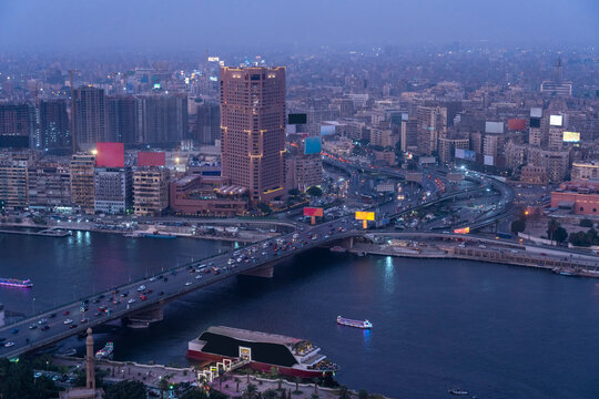 Egypt, Cairo, River Nile,QasrElNil Bridge and surrounding downtown buildingsat dusk