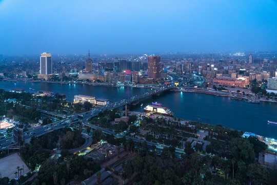 Egypt, Cairo, River Nile, Qasr El Nil Bridge and surrounding downtown buildings at dusk