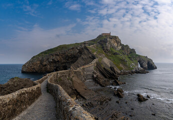 Obraz premium view of the church of San Juan de Gaztelugatxe and long stone stairs leading to it