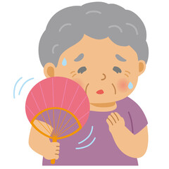 うちわで扇ぐシニア女性