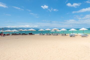 Fototapeta na wymiar Nha Trang beach with umbrellas and chairs 