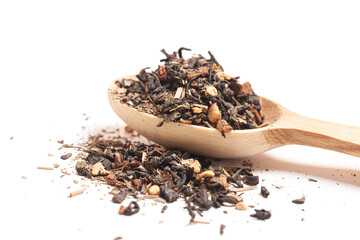 Delicious and healthy herbal green tropical tea with dried fruits in a wooden spoon isolated on white background.