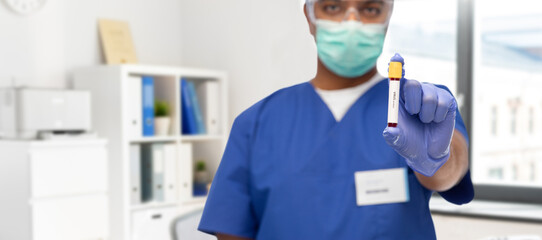 Fototapeta na wymiar healthcare, coronavirus and medicine concept - close up of doctor or male nurse in mask for protection from virus, goggles and gloves with blood in test tube over medical office at hospital background
