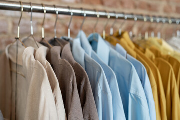 Organic eco clothes on hanger in store, soft focus. Home-made clothing from natural and processed...