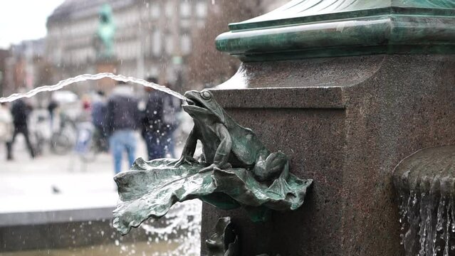 Frog detail Stork fountain in Copenhagen central square Denmark oxidized copper slowmotion