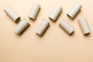 Flat lay composition with empty toilet paper rolls and space for text on color background. Recyclable paper tube with metal plug end made of kraft paper or cardboard