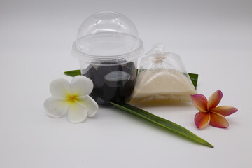 Obraz na płótnie Canvas Thai dessert, grass jelly, coconut milk put in a plastic box and plastic bags.Include Clipping Path.