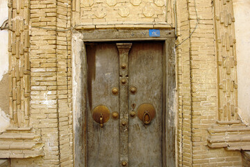 Old traditional persian door in old town district of Yazd city in Iran.