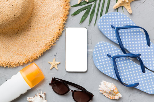 Flat lay composition with Phone and beach accessories on colored background. Smartphone with blank screen mock up with copy space