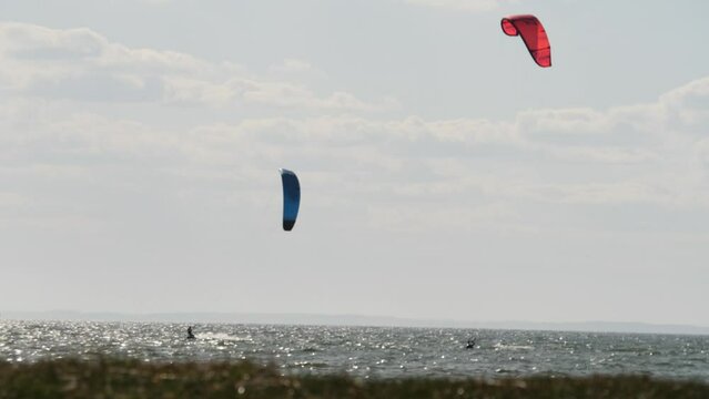 Kiteboarding or Kitesurfing, Blue and Red Kiter, Long Shot, Slow Motion