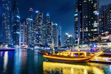 Fotobehang Dubai marina and traditional boat in UAE at night © Photocreo Bednarek