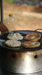 Street hawker preparing prata bread or roti canai for morning breakfast