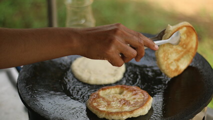 Street hawker preparing prata bread or roti canai for morning breakfast