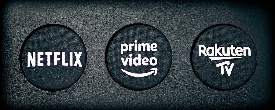 Neu-Ulm, Bavaria, Germany - May, 16 2022: Close-up of buttons on the remote control to choice between Netflix, Amazon prime and Rakuten TV.  