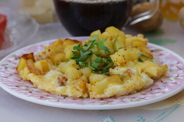 Delicious morning meal made with potatoes , cheese and eggs .Breakfast .