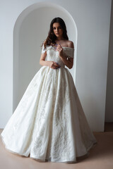 Beautiful bride posing in wedding dress in a white photo Studio.