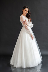 Fototapeta premium portrait of beautiful bride in wedding dress with fashion hairstyle and make-up