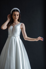 Fototapeta premium The beautiful woman posing in a wedding dress