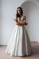 The beautiful woman posing in a wedding dress