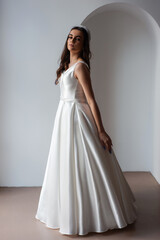 Fototapeta premium The beautiful woman posing in a wedding dress