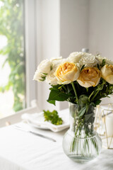 beautiful table setting for romantic dinner for two, roses bouquet copy space