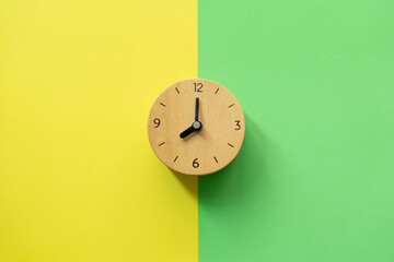 Fototapeta na wymiar Retro alarm clock on yellow and green table background, vintage style, flat lay