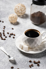 fresh hot black coffee in a glass on a light background