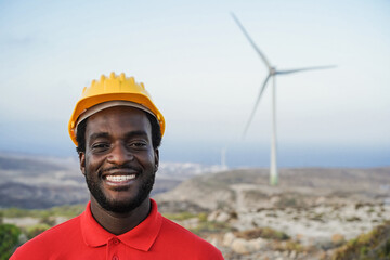 African engineer man working on a windmill farm - Focus on face