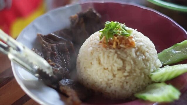 Buffalo meat with rice. The meat is stewed and topped with rice