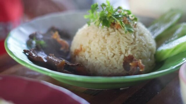 Buffalo meat with rice. The meat is stewed and topped with rice