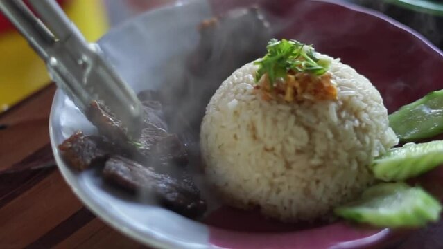 Buffalo meat with rice. The meat is stewed and topped with rice
