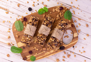 Useful granola bars on a wooden background.Flet lay  © Olivka888