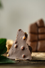 scary photo of chocolate, ugly photo of milk chocolate, slices of chocolate on white background, mint and raspberry leaves on white background, photo of chocolate for magazine with space for text