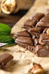 scary photo of chocolate, ugly photo of milk chocolate, slices of chocolate on white background, mint and raspberry leaves on white background, photo of chocolate for magazine with space for text