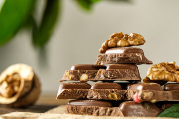 scary photo of chocolate, ugly photo of milk chocolate, slices of chocolate on white background, mint and raspberry leaves on white background, photo of chocolate for magazine with space for text