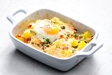 potatoes baked with smoked meat, green peas and cheddar cheese served with fired egg