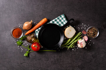Assortment of vegetables, herbs and spices on black background. Top view. Copy space	