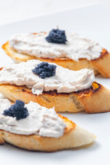 toasted baguette with tuna spread and black caviar