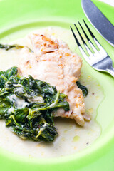 poultry breast with spinach leaves and sauce