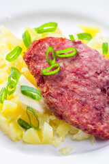 slice of meatloaf with potatoes and spring  onion